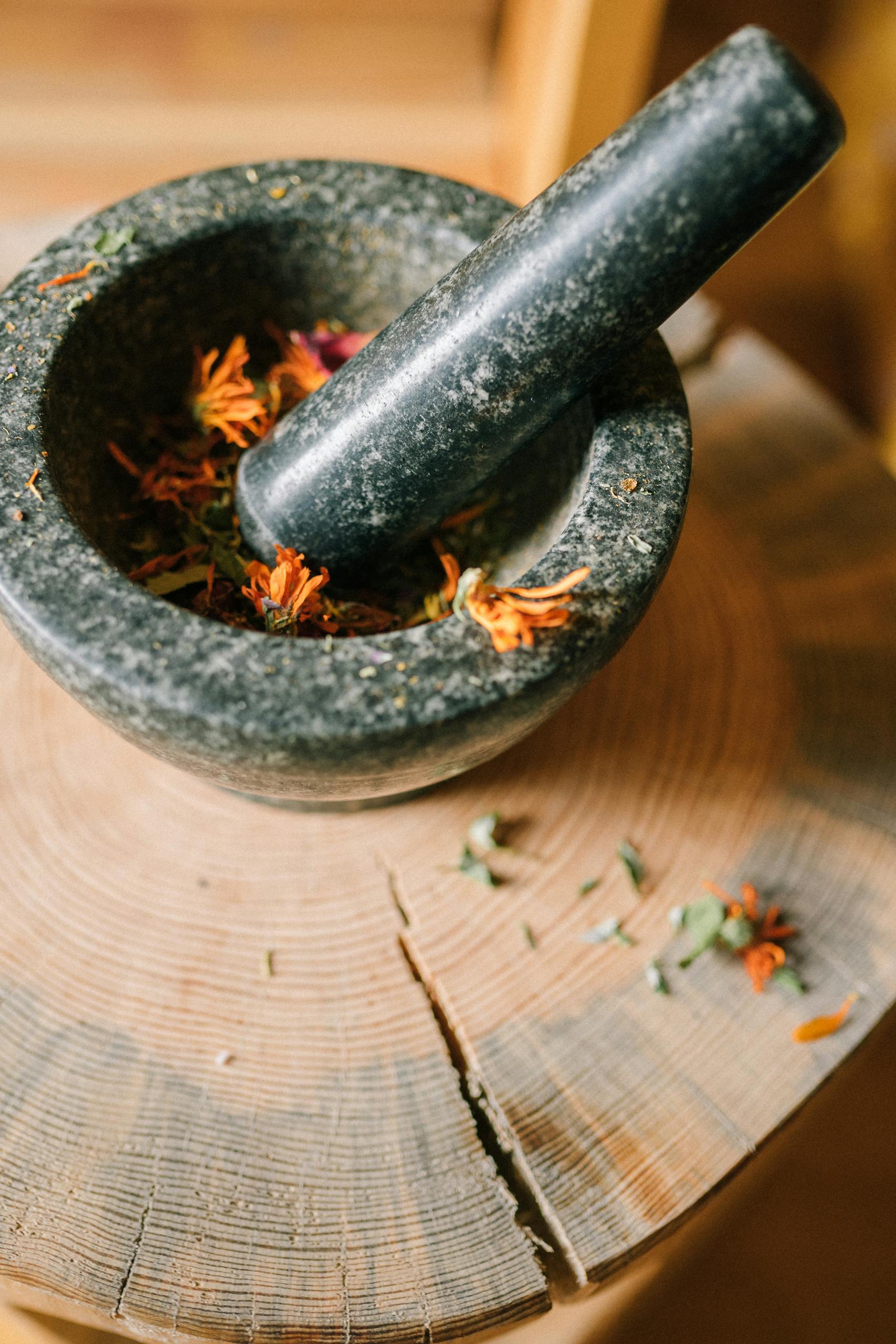 A Mortar and Pestle over a Wooden Board