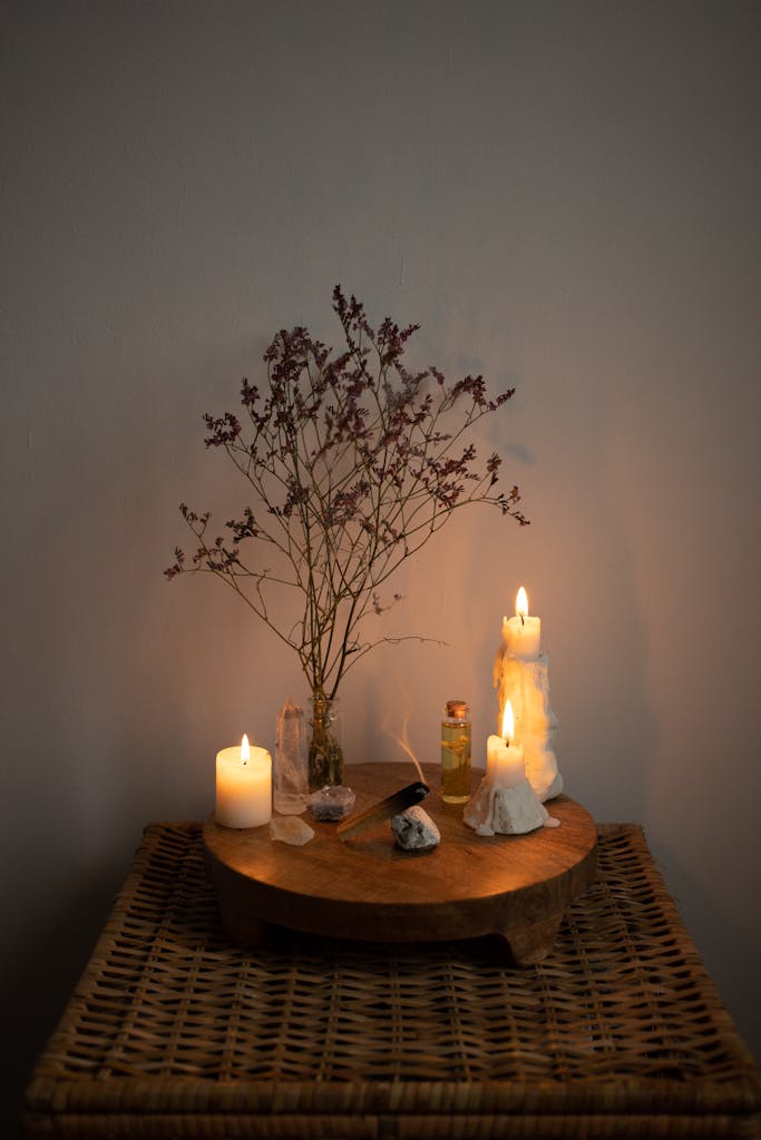 Warm candlelit setting with rustic plant decor on woven table, perfect for relaxation.