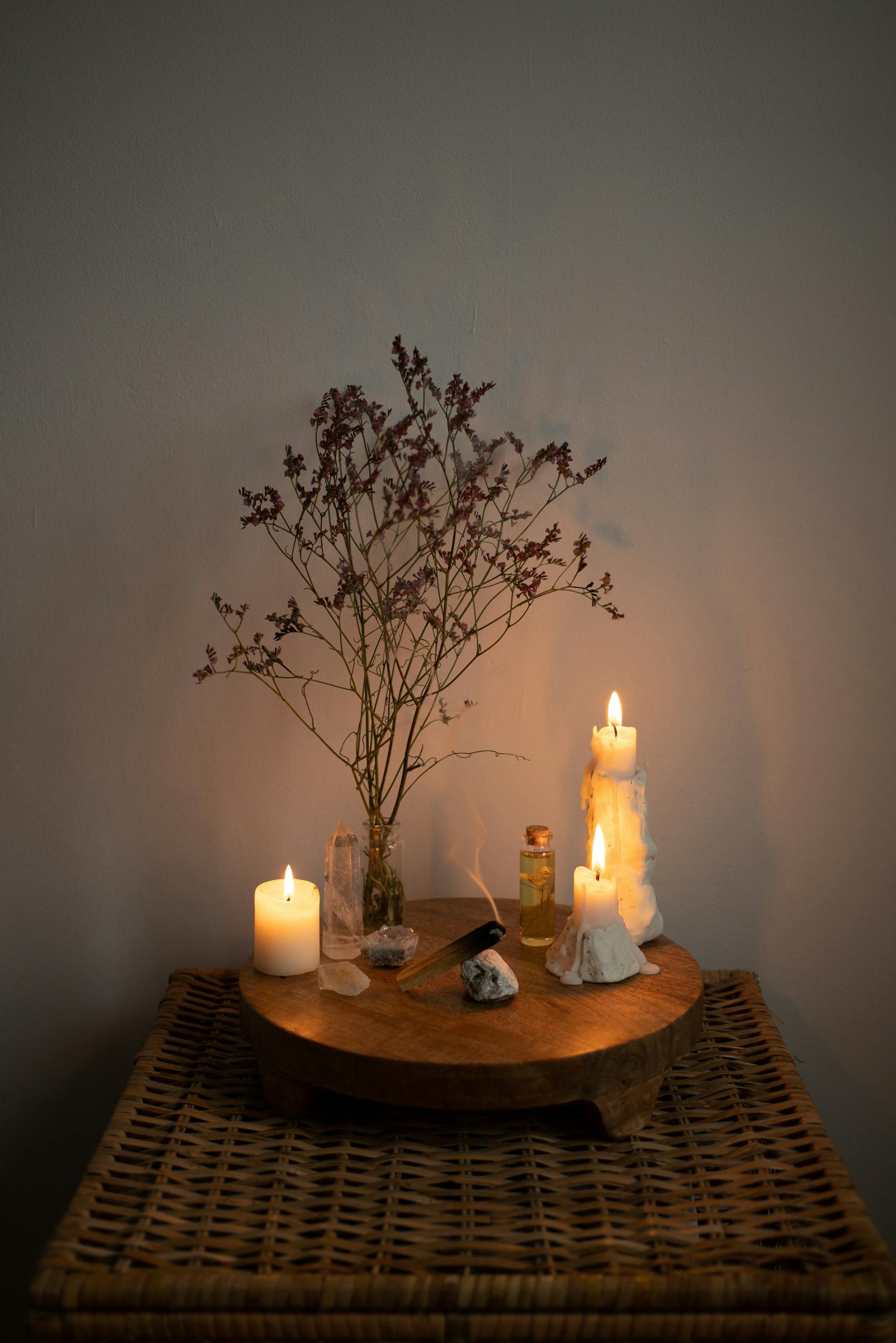 Warm candlelit setting with rustic plant decor on woven table, perfect for relaxation.